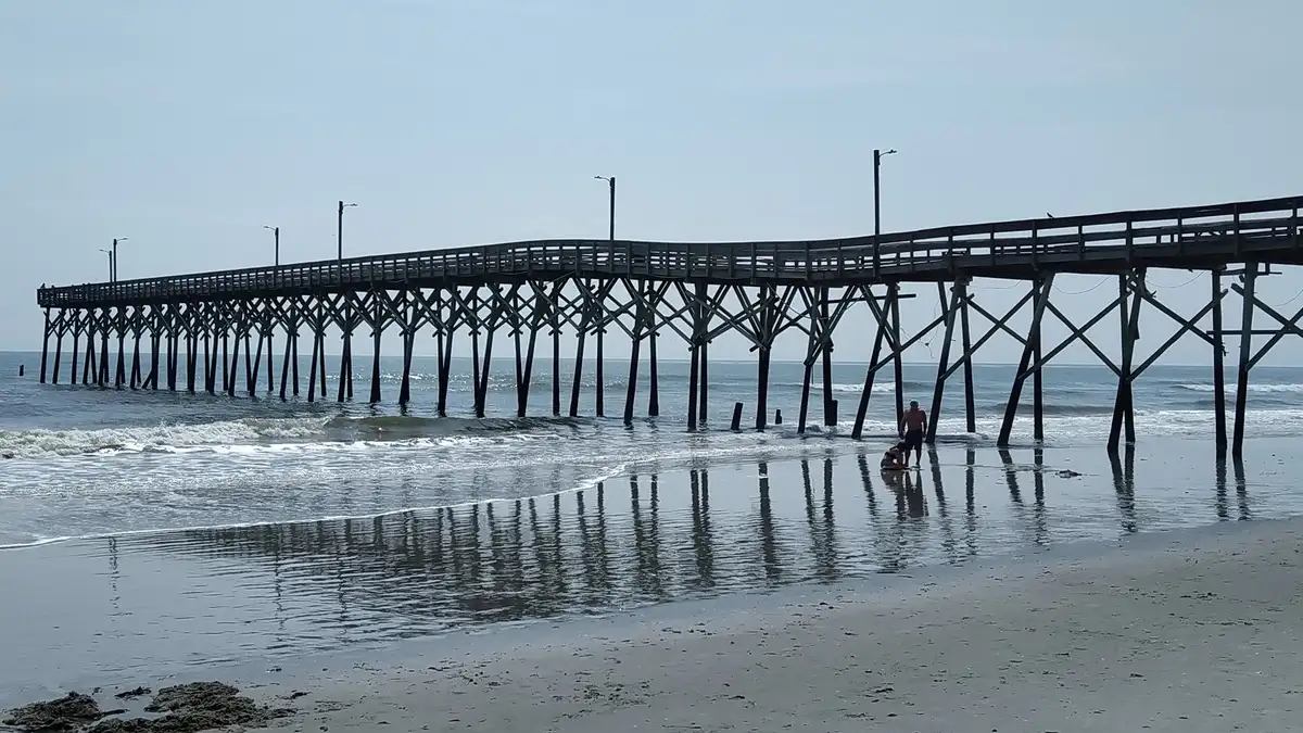 Holden Beach Fishing Pier reflected in the wet sand