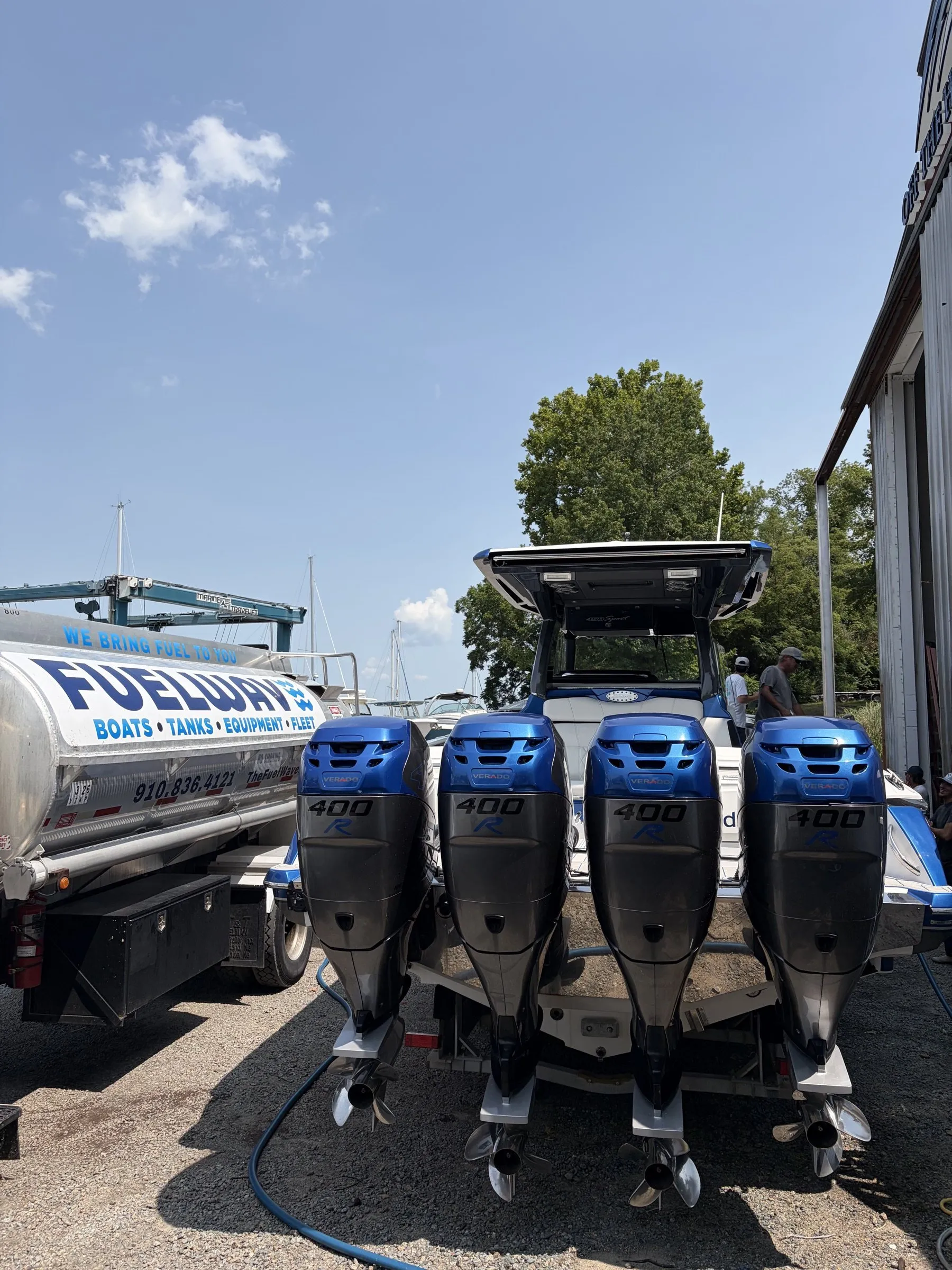 The Fuel Wave tanker beside a center console with quad outboards at the boatyard