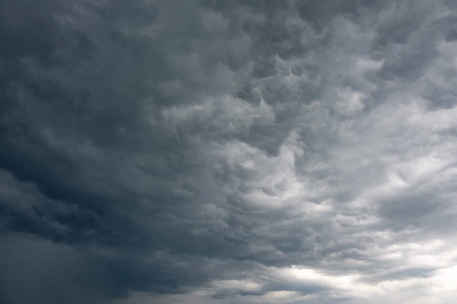 Heavy storm cloud building over open sky